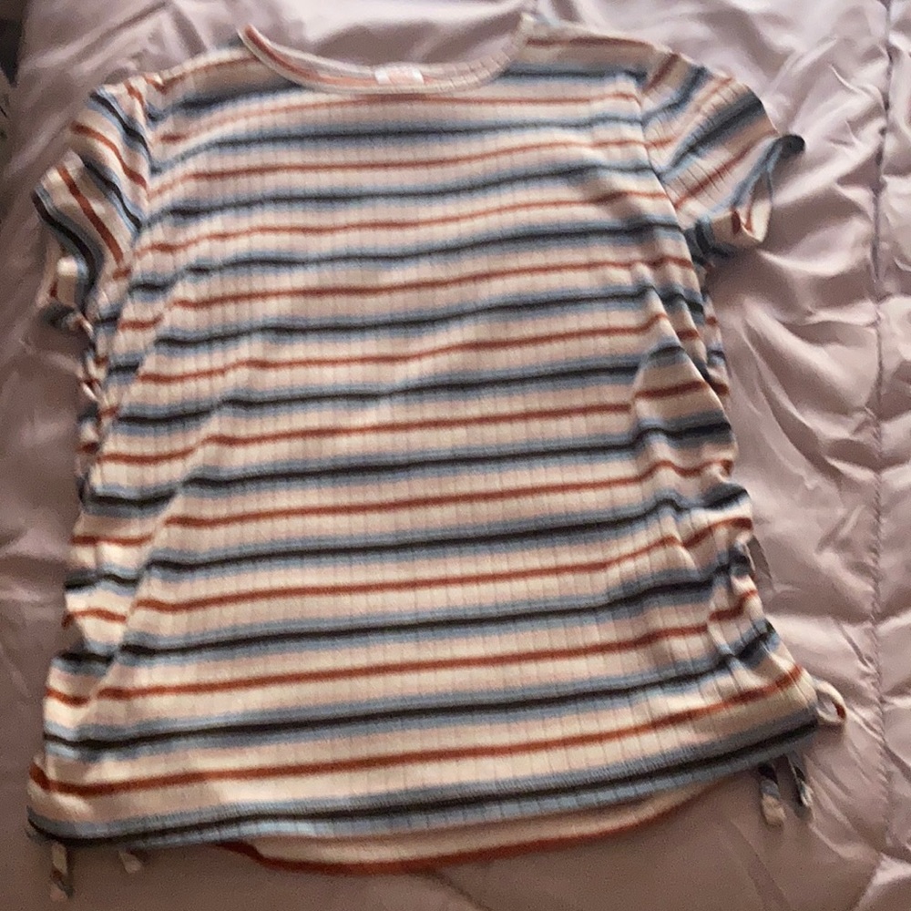 A t shirt it has blue red and black stripes. It is a very pretty shirt for kids